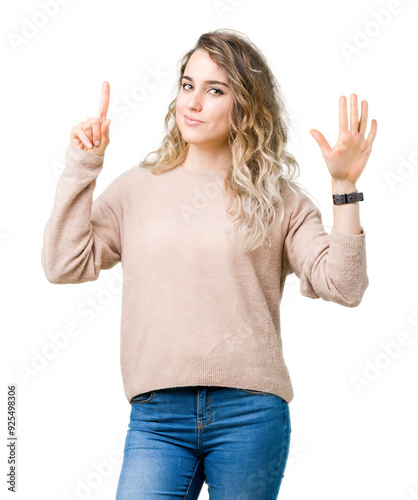 Beautiful young blonde woman wearing sweatershirt over isolated background showing and pointing up with fingers number six while smiling confident and happy. photo