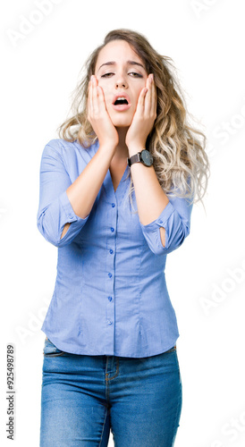 Beautiful young blonde business woman over isolated background Tired hands covering face, depression and sadness, upset and irritated for problem