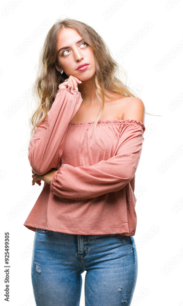 Beautiful young blonde woman over isolated background with hand on chin thinking about question, pensive expression. Smiling with thoughtful face. Doubt concept. Beautiful young blonde woman over isolated background with hand on chin thinking about question, pensive expression. Smiling with thoughtful face. Doubt concept.