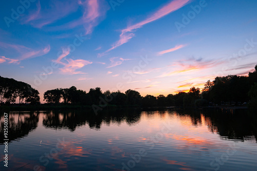 Beautiful reflections of pink colored clouds in a lake