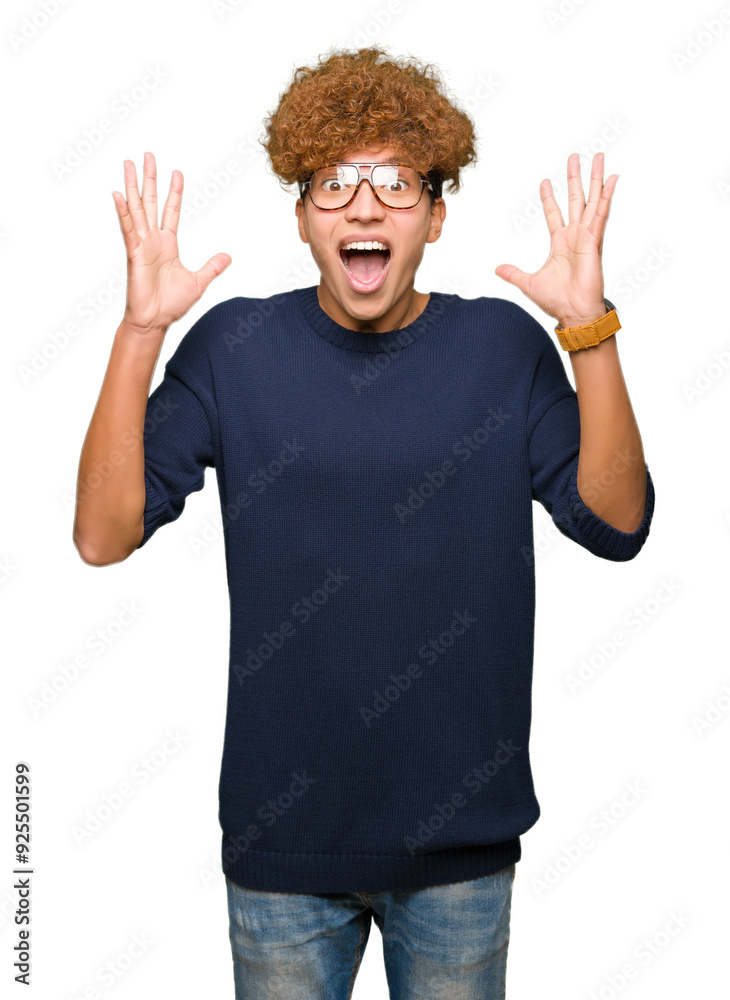 Young handsome man with afro wearing glasses celebrating crazy and amazed for success with arms raised and open eyes screaming excited. Winner concept Young handsome man with afro wearing glasses celebrating crazy and amazed for success with arms raised and open eyes screaming excited. Winner concept