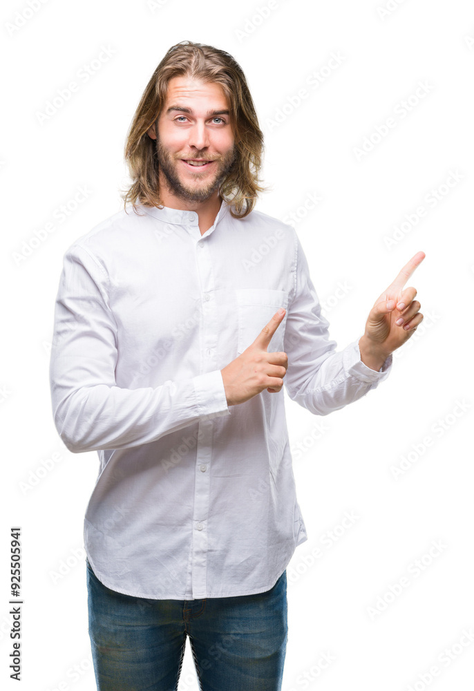 Young handsome man with long hair over isolated background smiling and looking at the camera pointing with two hands and fingers to the side. Young handsome man with long hair over isolated background smiling and looking at the camera pointing with two hands and fingers to the side.