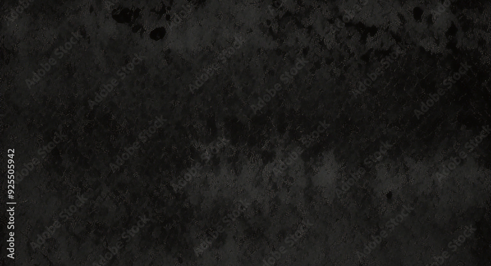 Fototapeta premium Black background made of real, shiny black paper covered with foil, illuminated by a soft light from above. 