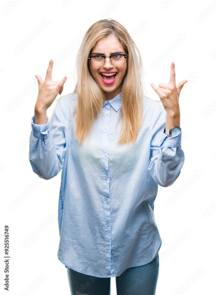 Young beautiful blonde business woman wearing glasses over isolated background shouting with crazy expression doing rock symbol with hands up. Music star. Heavy concept. Young beautiful blonde business woman wearing glasses over isolated background shouting with crazy expression doing rock symbol with hands up. Music star. Heavy concept.