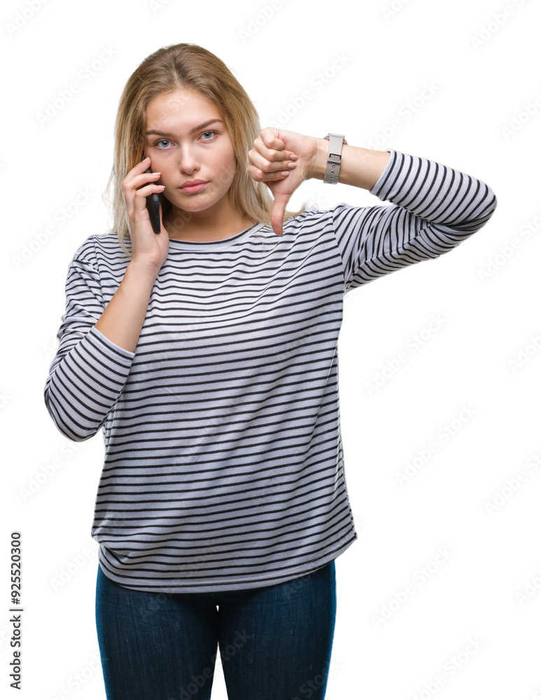 Young caucasian woman showing smartphone screen over isolated background with angry face, negative sign showing dislike with thumbs down, rejection concept Young caucasian woman showing smartphone screen over isolated background with angry face, negative sign showing dislike with thumbs down, rejection concept
