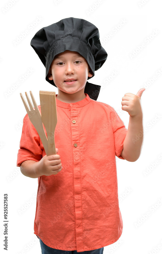 Dark haired little child wearing chef uniform happy with big smile doing ok sign, thumb up with fingers, excellent sign Dark haired little child wearing chef uniform happy with big smile doing ok sign, thumb up with fingers, excellent sign