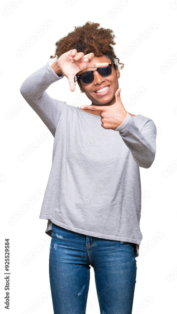 Beautiful young african american woman wearing sunglasses over isolated background smiling making frame with hands and fingers with happy face. Creativity and photography concept. Beautiful young african american woman wearing sunglasses over isolated background smiling making frame with hands and fingers with happy face. Creativity and photography concept.