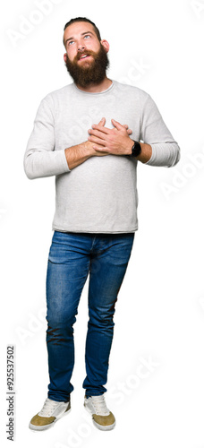 Young blond man wearing casual sweater smiling with hands on chest with closed eyes and grateful gesture on face. Health concept.