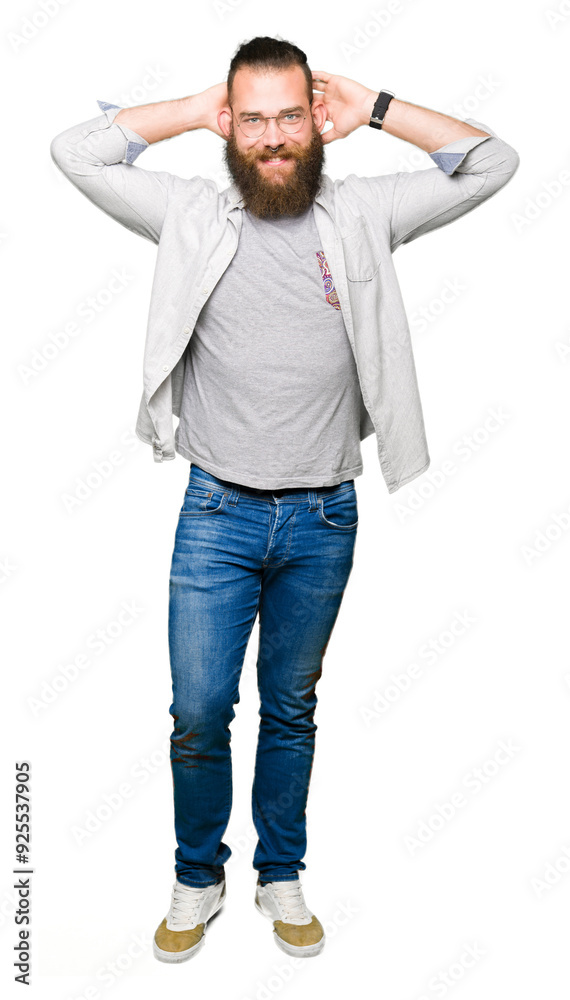 Young blond man wearing glasses Relaxing and stretching with arms and hands behind head and neck, smiling happy Young blond man wearing glasses Relaxing and stretching with arms and hands behind head and neck, smiling happy