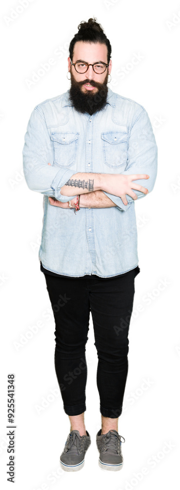 Young hipster man with long hair and beard wearing glasses skeptic and nervous, disapproving expression on face with crossed arms. Negative person. Young hipster man with long hair and beard wearing glasses skeptic and nervous, disapproving expression on face with crossed arms. Negative person.