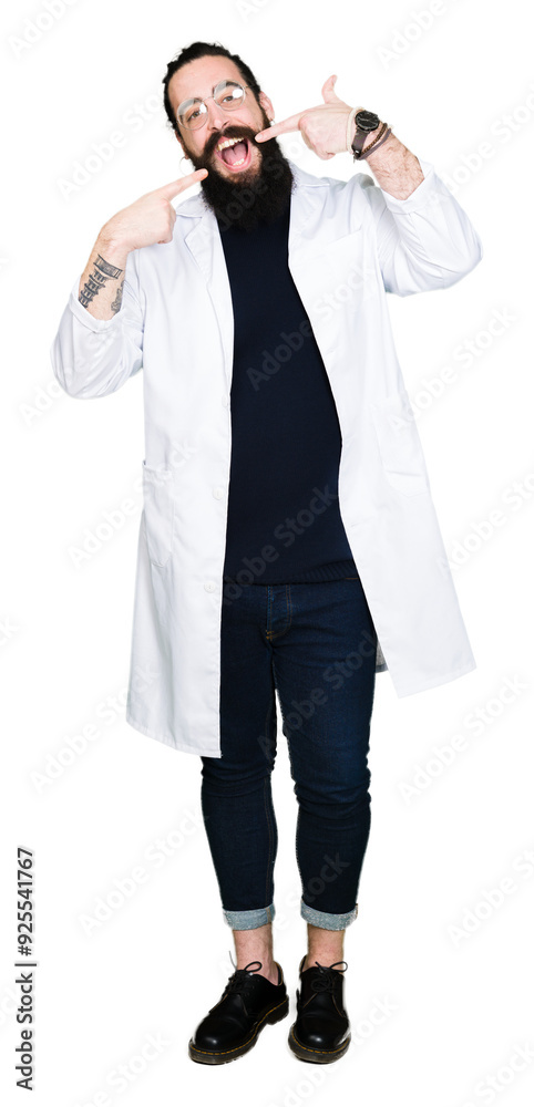 Doctor therapist man with long hair and bear wearing white coat smiling confident showing and pointing with fingers teeth and mouth. Health concept. Doctor therapist man with long hair and bear wearing white coat smiling confident showing and pointing with fingers teeth and mouth. Health concept.