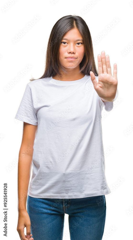 Young asian woman over isolated background doing stop sing with palm of the hand. Warning expression with negative and serious gesture on the face. Young asian woman over isolated background doing stop sing with palm of the hand. Warning expression with negative and serious gesture on the face.