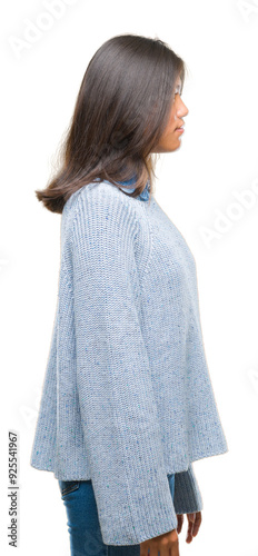 Young asian woman wearing winter sweater over isolated background looking to side, relax profile pose with natural face with confident smile.