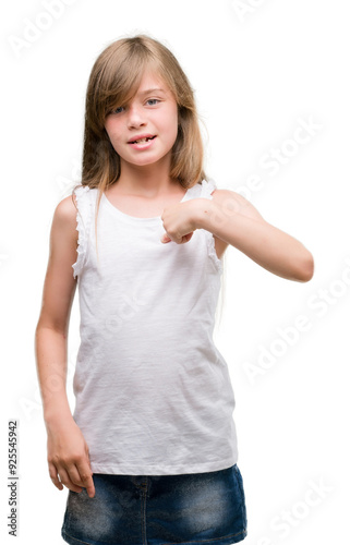 Young blonde toddler with surprise face pointing finger to himself