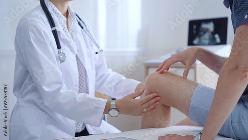 Doctor is carefully examining a patient's knee, providing personalized care and support. Medicine and orthopedic concept photo