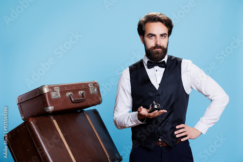 Slika na platnu Male bellboy with baggage and bell used to ring for service or help at hotel reception in hospitality industry