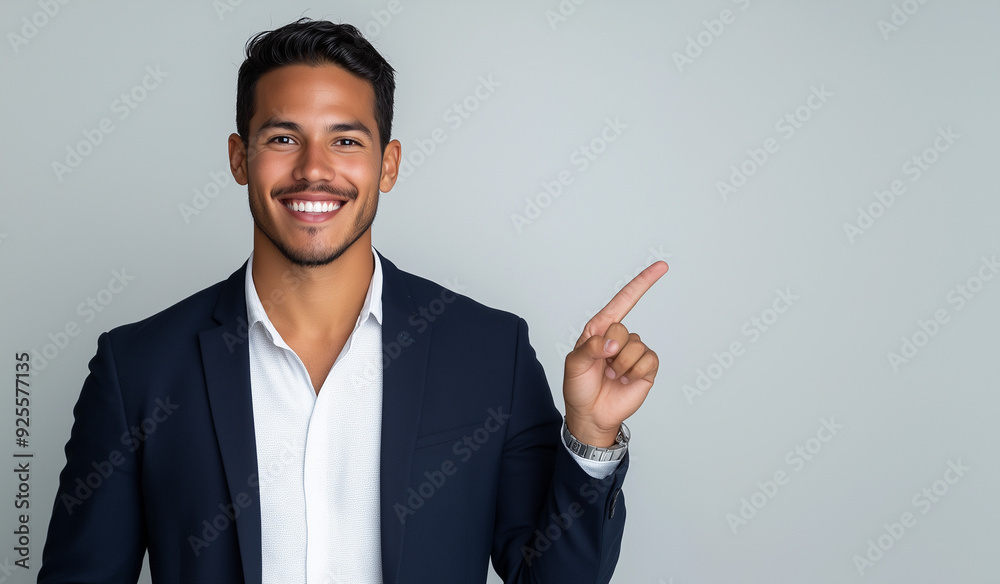 Studio portrait of A handsome latin man with a smile on his face pointing at an empty space wearing casual clothes isolated on a colored background for advertising or just copy space Studio portrait of A handsome latin man with a smile on his face pointing at an empty space wearing casual clothes isolated on a colored background for advertising or just copy space