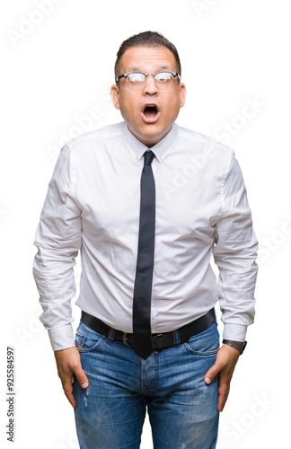 Middle age bussines arab man wearing glasses over isolated background afraid and shocked with surprise expression, fear and excited face.