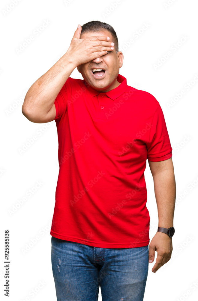 Middle age arab man over isolated background smiling and laughing with hand on face covering eyes for surprise. Blind concept. Middle age arab man over isolated background smiling and laughing with hand on face covering eyes for surprise. Blind concept.