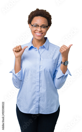 Young beautiful african american business woman over isolated background Pointing to the back behind with hand and thumbs up, smiling confident photo