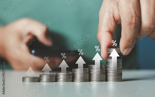 Interest rate and dividend concept. Businessman stacking coins money with up arrow and percentage symbol for financial banking increase interest rate or mortgage investment dividend business growth. photo