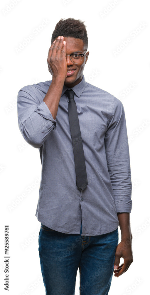 Young african american business man over isolated background covering one eye with hand with confident smile on face and surprise emotion. Young african american business man over isolated background covering one eye with hand with confident smile on face and surprise emotion.