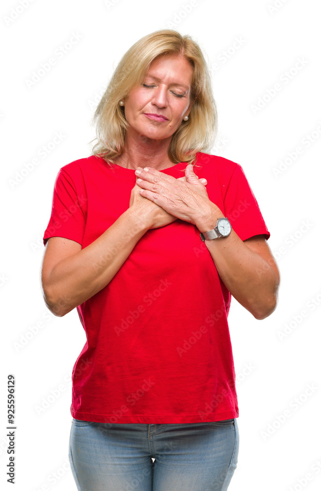 Middle age blonde woman over isolated background smiling with hands on chest with closed eyes and grateful gesture on face. Health concept. Middle age blonde woman over isolated background smiling with hands on chest with closed eyes and grateful gesture on face. Health concept.