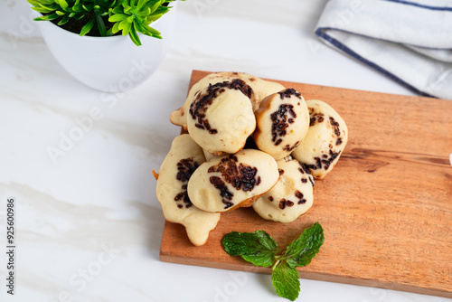 Kue Cubit. Indonesian version of Dutch poffertjes; topped with chocolate sprinkles. Perfect for design element, product packaging, promotion, or any commercial purposes.
