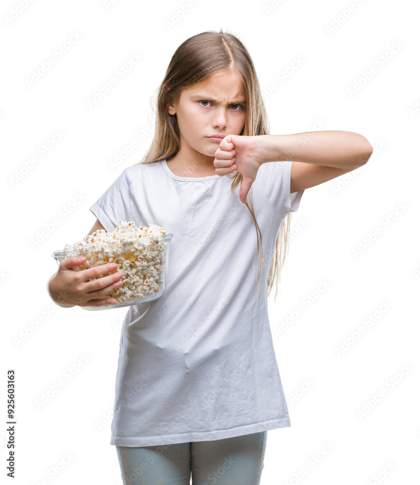Young beautiful girl eating popcorn snack isolated background with angry face, negative sign showing dislike with thumbs down, rejection concept Young beautiful girl eating popcorn snack isolated background with angry face, negative sign showing dislike with thumbs down, rejection concept