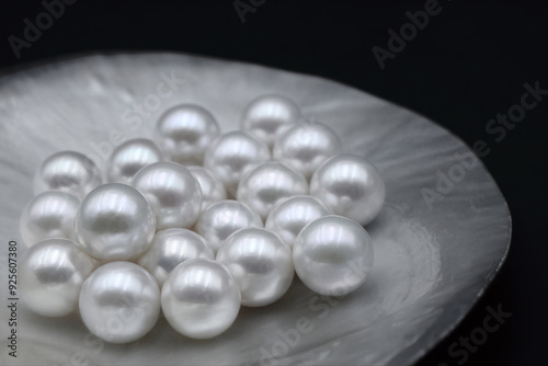 Expensive luxurious Chinese freshwater round pearls in a white shell, to be made into earrings, pendants or necklaces and sold in jewelry store. Popular feminine wedding accessory.