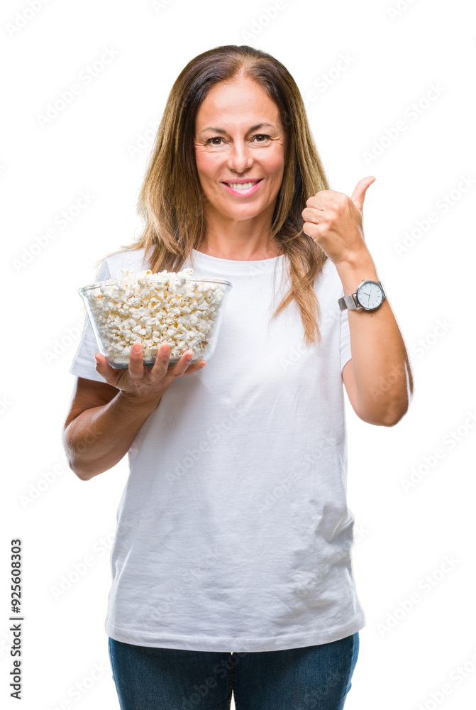 Middle age hispanic woman eating popcorn over isolated background happy with big smile doing ok sign, thumb up with fingers, excellent sign Middle age hispanic woman eating popcorn over isolated background happy with big smile doing ok sign, thumb up with fingers, excellent sign