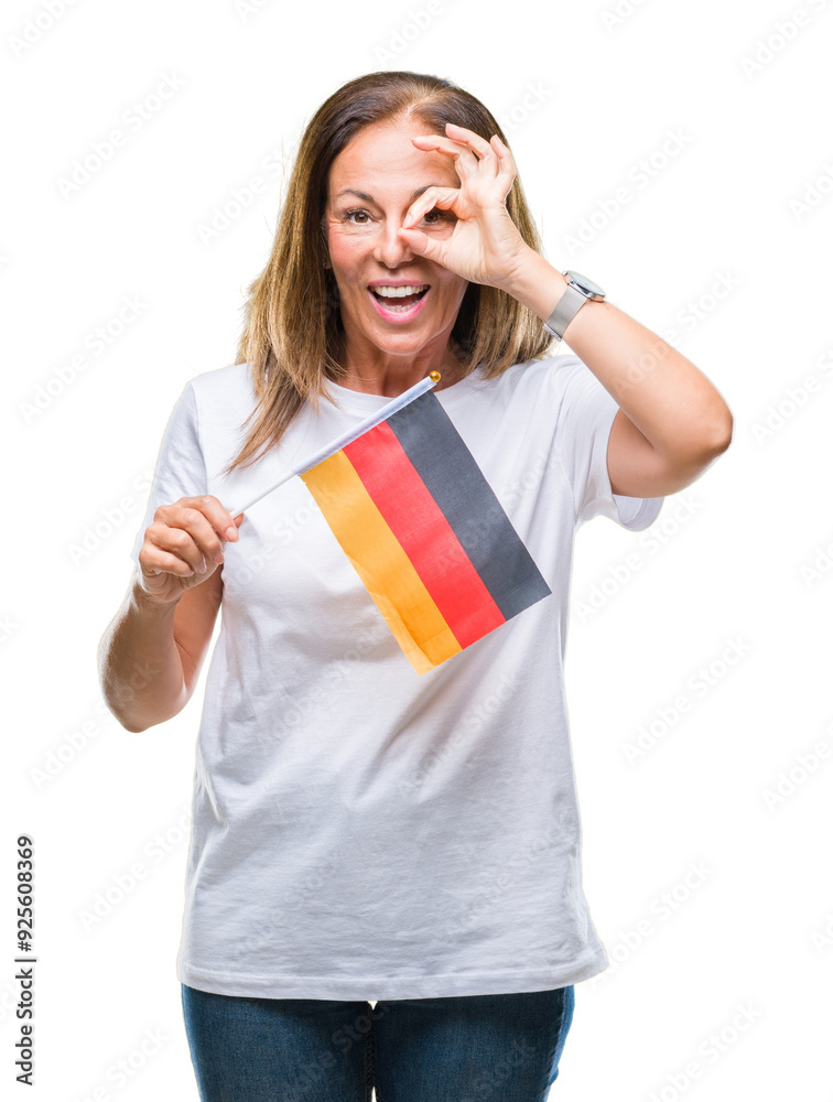 Middle age hispanic woman holding flag of Germany over isolated background with happy face smiling doing ok sign with hand on eye looking through fingers Middle age hispanic woman holding flag of Germany over isolated background with happy face smiling doing ok sign with hand on eye looking through fingers