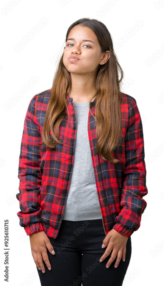 Young beautiful brunette woman wearing a jacket over isolated background puffing cheeks with funny face. Mouth inflated with air, crazy expression. Young beautiful brunette woman wearing a jacket over isolated background puffing cheeks with funny face. Mouth inflated with air, crazy expression.