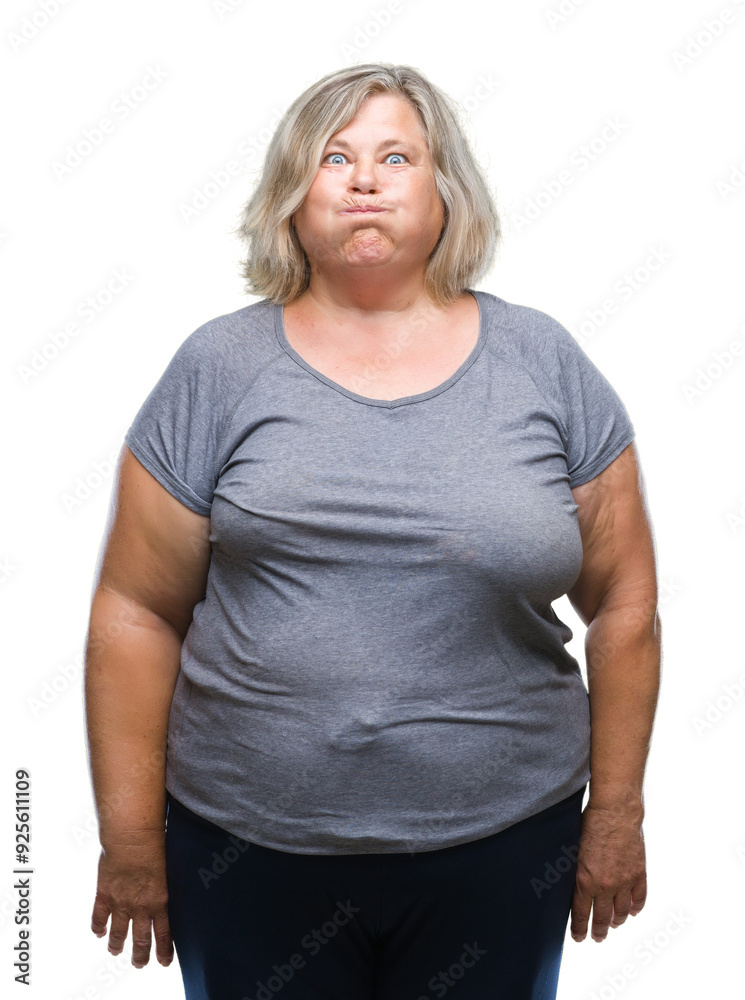 Senior plus size caucasian woman over isolated background puffing cheeks with funny face. Mouth inflated with air, crazy expression. Senior plus size caucasian woman over isolated background puffing cheeks with funny face. Mouth inflated with air, crazy expression.