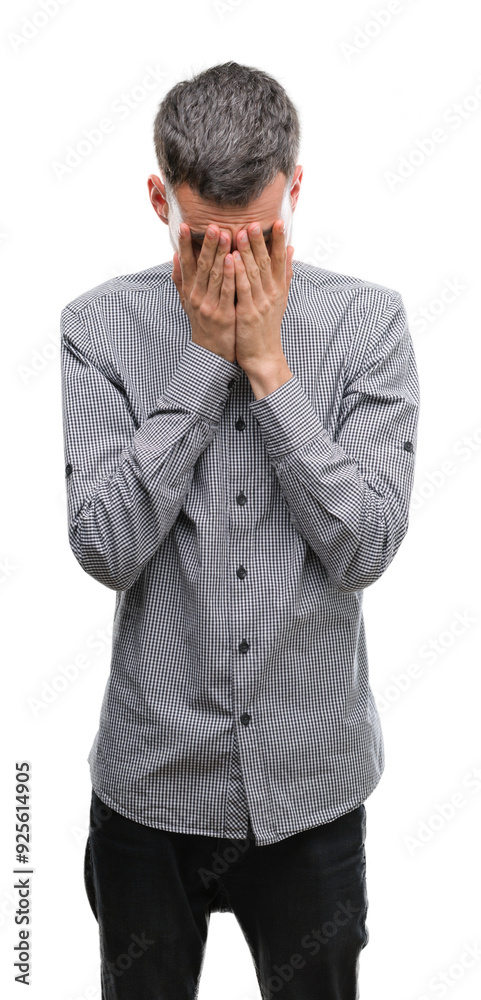 Young hipster man with sad expression covering face with hands while crying. Depression concept. Young hipster man with sad expression covering face with hands while crying. Depression concept.