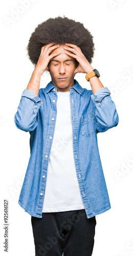 Fotografie Young african american man with afro hair suffering from headache desperate and stressed because pain and migraine