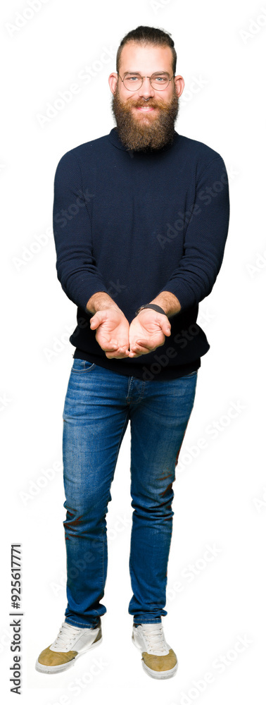 Young blond man wearing glasses and turtleneck sweater Smiling with hands palms together receiving or giving gesture. Hold and protection Young blond man wearing glasses and turtleneck sweater Smiling with hands palms together receiving or giving gesture. Hold and protection