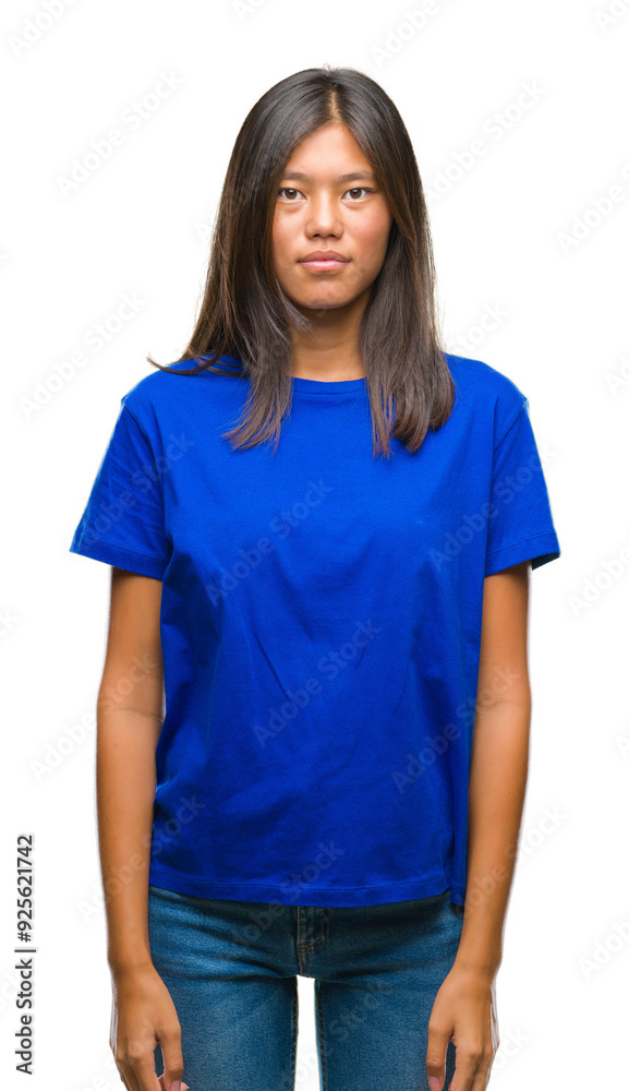 Fototapeta premium Young asian woman over isolated background with serious expression on face. Simple and natural looking at the camera.