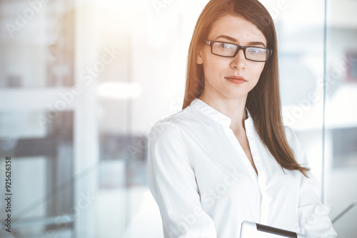 Beautiful female specialist with tablet computer standing in sunny office and smiling charmingly. Business people concept Free Download Beautiful female specialist with tablet computer standing in sunny office and smiling charmingly. Business people concept - GFXLoad
