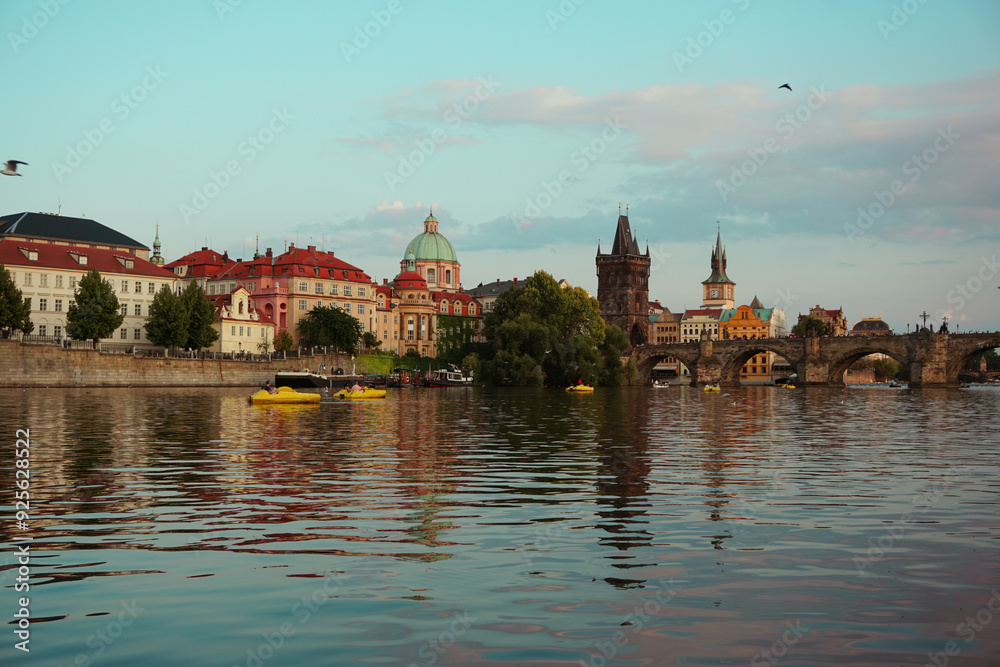 View of buildings by river against cloudy sky View of buildings by river against cloudy sky