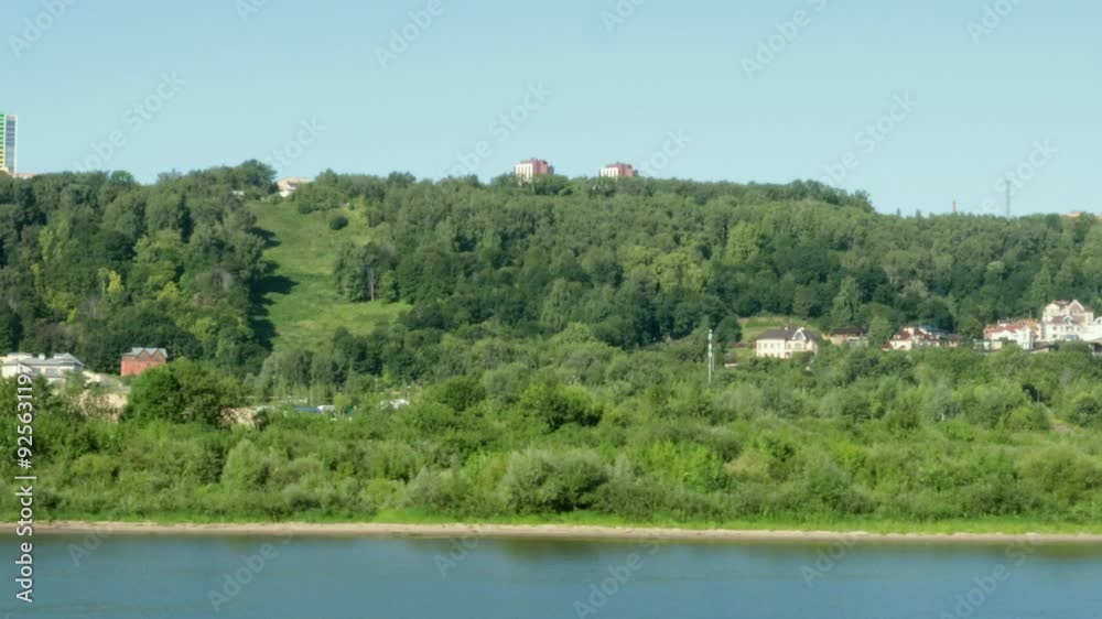 4k video, view from the deck of a ship sailing along the river and bobbing on the waves, on the green wooded shore and houses along the river 4k video, view from the deck of a ship sailing along the river and bobbing on the waves, on the green wooded shore and houses along the river