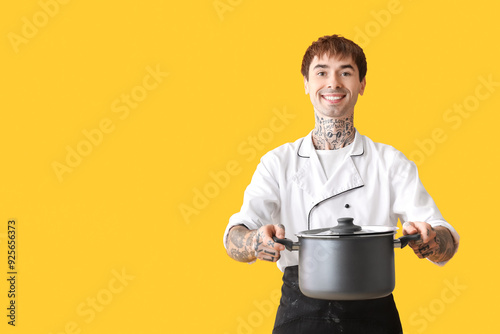 Tattooed happy male chef wi...