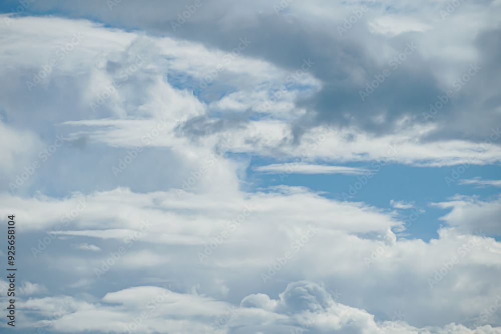 Cloudy fluffy sky natural background. Blue and white cloudscape. Transition of gently cloud scape at summer day. Clean of birds, bugs, and dust. Cloudy fluffy sky natural background. Blue and white cloudscape. Transition of gently cloud scape at summer day. Clean of birds, bugs, and dust.