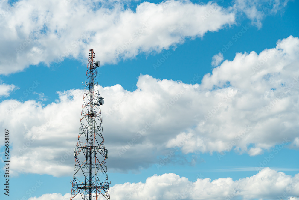 Mobile phone communication radio antenna, 3G, 4G, 5G, 6G. Antenna over cloudy blue sky at summer. Cellular GSM tower with transmitter. Telecommunication base station network. Mobile phone communication radio antenna, 3G, 4G, 5G, 6G. Antenna over cloudy blue sky at summer. Cellular GSM tower with transmitter. Telecommunication base station network.