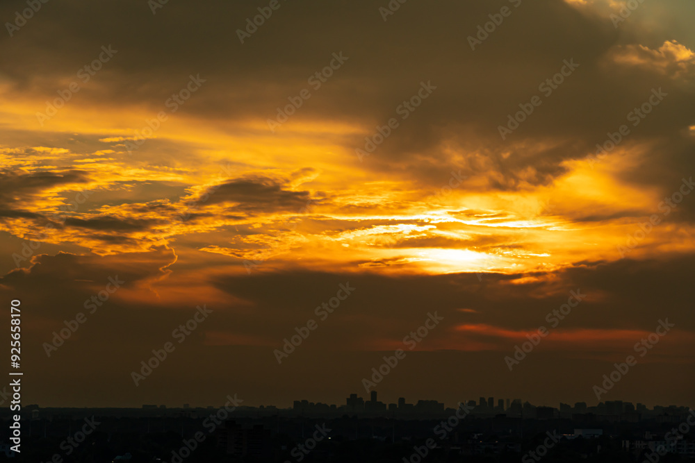 Fototapeta premium Sunset cityscape. Amazing red orange evening clouds and sun in the American city. Cloudscape summer nature. Clean of birds, bugs, and dust.