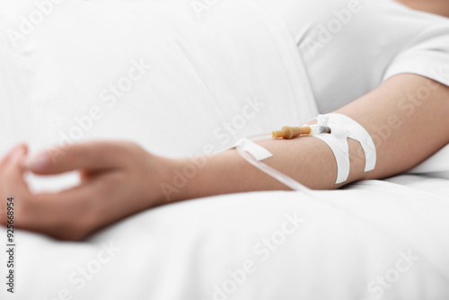 Coma patient. Woman with intravenous drip in hospital bed, closeup