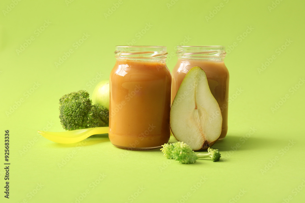 Glass jars with healthy baby puree and ingredients on color background Glass jars with healthy baby puree and ingredients on color background