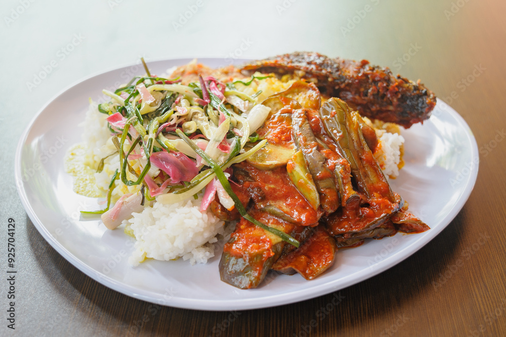 Typical Malaysian daily lunch called Nasi Campur which is loosely translated as rice mixed with vegetable, sliced meat, chicken or fish. Typical Malaysian daily lunch called Nasi Campur which is loosely translated as rice mixed with vegetable, sliced meat, chicken or fish.