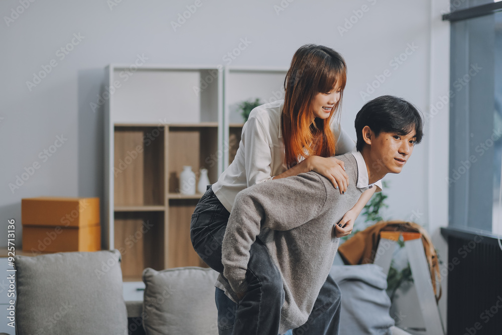 Asian Female discussing new project with male colleague. Young woman talking with young Asian man with financial on sofa in home office Asian Female discussing new project with male colleague. Young woman talking with young Asian man with financial on sofa in home office