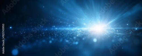 Stunning blue light abstract with luminous particles and soft rays enhancing the depth and dimension of the digital scene.